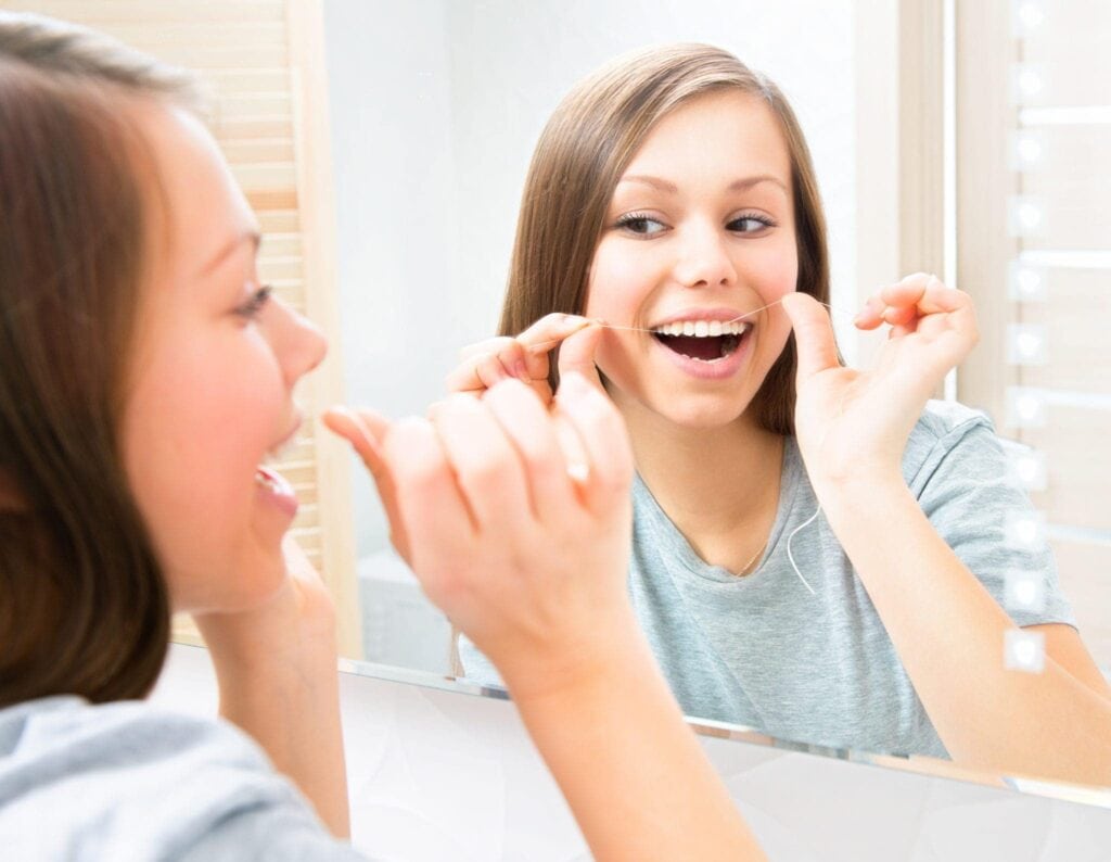 Flossing in the mirror
